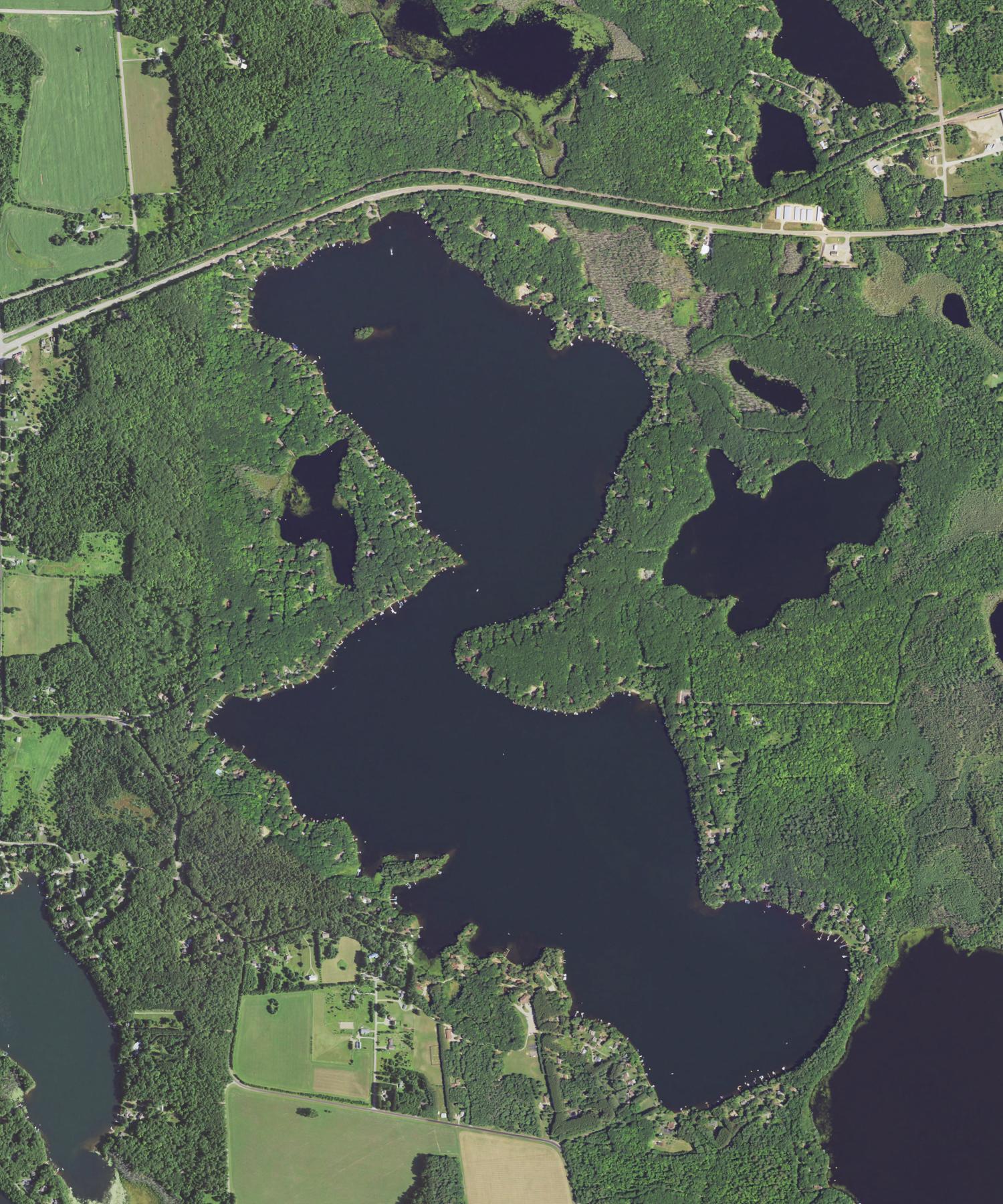 Overhead aerial view of Crescent Lake and its forested shoreline near Rhinelander, Wisconsin
